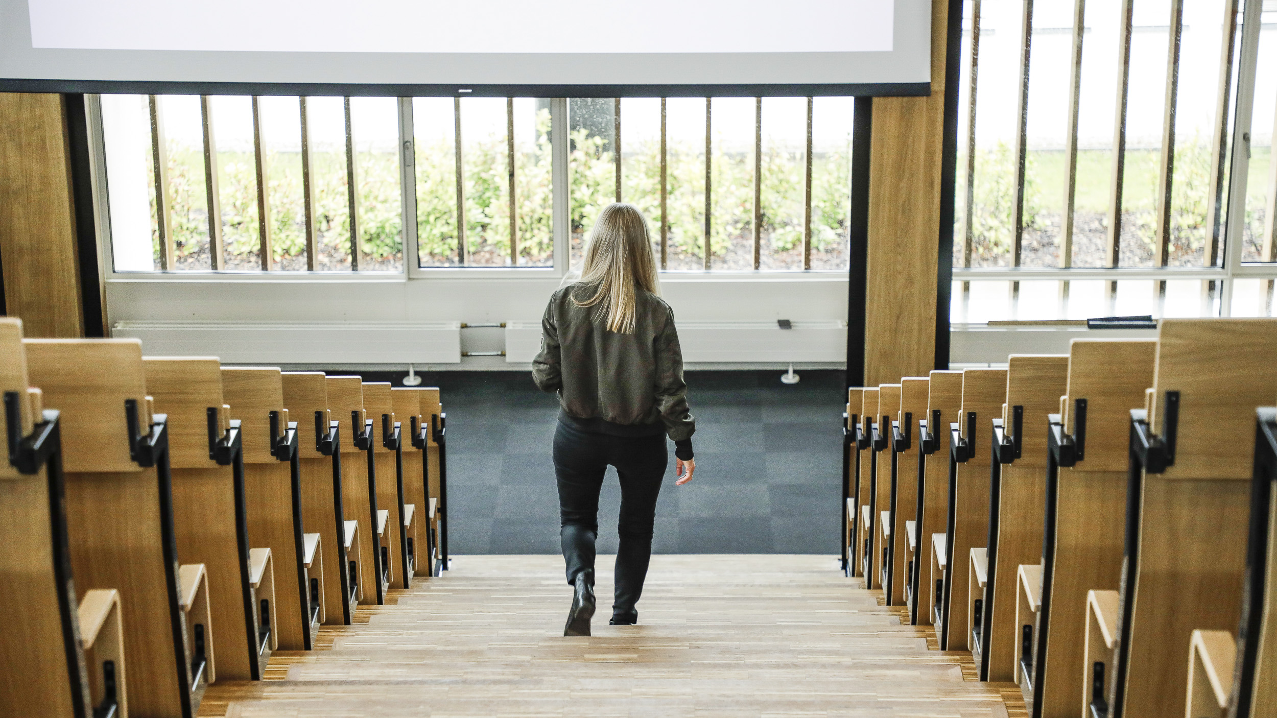 Kvinde går ned af trappen i auditorium